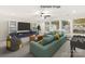 Spacious living room featuring a comfortable sofa, entertainment center, and large windows for ample natural light at 11009 Tyler Brook Ln # Oak0043, Mint Hill, NC 28227
