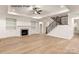 Spacious living room with a fireplace, built-in shelving, and staircase at 11009 Tyler Brook Ln # Oak0043, Mint Hill, NC 28227