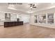 Open-concept living room with hardwood floors and views to a modern kitchen and outdoor space at 11009 Tyler Brook Ln # Oak0043, Mint Hill, NC 28227