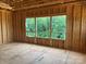 Unfinished room displaying exposed framing with a large window offering a natural view at 11009 Tyler Brook Ln # Oak0043, Mint Hill, NC 28227
