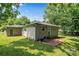 Backyard with a green door, siding, and brick patio at 1116 S Juniper St, Kannapolis, NC 28081