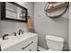 Bathroom featuring sleek white vanity, black hardware, and modern fixtures at 1116 S Juniper St, Kannapolis, NC 28081