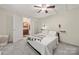 Bright bedroom featuring soft carpet, a ceiling fan, and an en-suite bathroom with modern finishes at 1116 S Juniper St, Kannapolis, NC 28081