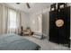 Bedroom featuring gray carpet, ceiling fan and bed next to an entry and closet at 1116 S Juniper St, Kannapolis, NC 28081