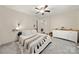 Light-filled bedroom with soft carpet, fan, and easy access to a closet and dresser for ample storage at 1116 S Juniper St, Kannapolis, NC 28081
