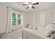Bright bedroom with plush carpeting, ceiling fan, and two large windows with sheer white curtains at 1116 S Juniper St, Kannapolis, NC 28081