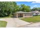 Inviting single-story home with brick and stone, a wide driveway, and a neatly kept lawn and landscaping at 1116 S Juniper St, Kannapolis, NC 28081