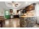 Spacious kitchen with dark wood cabinetry, stainless steel appliances, and a unique stone breakfast bar at 1116 S Juniper St, Kannapolis, NC 28081