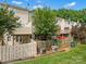 Townhome backyards with wooden fences and small patios, some with open storage at 1231 Maple Shade Ln, Charlotte, NC 28270