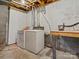 Unfinished basement with concrete walls, utilities, and a workbench at 1231 Maple Shade Ln, Charlotte, NC 28270