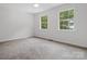Bedroom with neutral carpet features two large windows at 1231 Maple Shade Ln, Charlotte, NC 28270