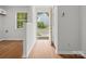 Bright foyer with wood-look flooring, white walls, window and view of the neighborhood at 1231 Maple Shade Ln, Charlotte, NC 28270