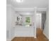 Open-concept kitchen featuring white cabinets and a view into the entry hall at 1231 Maple Shade Ln, Charlotte, NC 28270