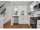 Modern kitchen with stainless steel appliances open to living room, and stairs at 1231 Maple Shade Ln, Charlotte, NC 28270