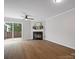 Bright living room featuring a fireplace, ceiling fan, and sliding glass door to the backyard at 1231 Maple Shade Ln, Charlotte, NC 28270