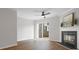 Cozy living room featuring a fireplace, ceiling fan, and sliding glass door to the backyard at 1231 Maple Shade Ln, Charlotte, NC 28270