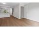 View of the living room with wood floors that extends to the entryway and stairs at 1231 Maple Shade Ln, Charlotte, NC 28270