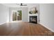 Bright living room features a fireplace, ceiling fan, and sliding glass door to the outside at 1231 Maple Shade Ln, Charlotte, NC 28270