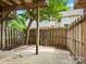 A small patio with a wooden fence, a wooden support column, and tree overhead at 1231 Maple Shade Ln, Charlotte, NC 28270
