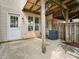 A small patio with a door to the house, with wooden support column, and a fenced border at 1231 Maple Shade Ln, Charlotte, NC 28270