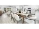 Open-concept dining area features a modern table with seating and blends seamlessly into the living room and kitchen at 1312 W Monroe Rd, Salisbury, NC 28144