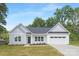 Charming single-Gathering home featuring a two-car garage and manicured front lawn with beautiful landscaping at 1312 W Monroe Rd, Salisbury, NC 28144