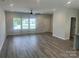 Spacious living room with large windows, ceiling fan, hardwood floors, and neutral paint at 1312 W Monroe Rd, Salisbury, NC 28144