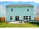 View of a two-story house with green siding and a backyard patio with outdoor seating at 133 Aspire Cir, Wingate, NC 28174