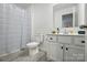 A clean, white bathroom with a shower, toilet, and vanity at 133 Aspire Cir, Wingate, NC 28174