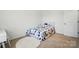 Bright bedroom features soft carpet, plush bed, and ample natural light at 133 Aspire Cir, Wingate, NC 28174