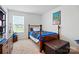 Bright bedroom with a wood frame bed and a video game themed design at 133 Aspire Cir, Wingate, NC 28174