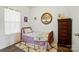 Bright bedroom with a bed, dresser, neutral walls, decorative artwork, and a light-filled window at 133 Aspire Cir, Wingate, NC 28174