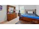A bedroom with a wood frame bed, dresser, and carpet floors at 133 Aspire Cir, Wingate, NC 28174