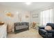 Cozy Bedroom features neutral tones, floral accents, and comfortable seating at 133 Aspire Cir, Wingate, NC 28174