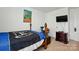 A bedroom with a wood frame bed and a TV on the wall at 133 Aspire Cir, Wingate, NC 28174