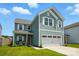 Charming two-story home with a well-maintained lawn, inviting porch, and a two-car garage at 133 Aspire Cir, Wingate, NC 28174