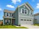 Charming two-story home with a two-car garage, front porch, and lush green lawn at 133 Aspire Cir, Wingate, NC 28174