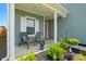 Inviting front porch with seating, vibrant plants, and a charming view at 133 Aspire Cir, Wingate, NC 28174