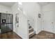 Hallway near the garage with a refrigerator and a staircase to the second floor at 133 Aspire Cir, Wingate, NC 28174