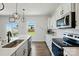 Kitchen with bright white cabinets, stainless appliances and outdoor view at 133 Aspire Cir, Wingate, NC 28174