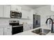 Well-lit kitchen with stainless steel appliances and white subway tile backsplash at 133 Aspire Cir, Wingate, NC 28174