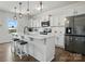 Well-lit kitchen with stainless steel appliances, a breakfast bar and view to the backyard at 133 Aspire Cir, Wingate, NC 28174