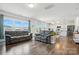 Bright living room and kitchen area with wood floors and large windows showcasing the outdoor scenery at 133 Aspire Cir, Wingate, NC 28174