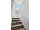 Bright staircase leading to the second floor with white railing and walls at 133 Aspire Cir, Wingate, NC 28174