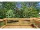 A wood deck with black metal railings offers a view of the back yard at 136 Digh Cir # 4, Mooresville, NC 28117