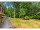 View of the beautiful backyard and wooded lot complete with stamped concrete walkway at 136 Digh Cir # 4, Mooresville, NC 28117