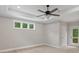 This bedroom features three windows, ceiling fan, and access to the private deck at 136 Digh Cir # 4, Mooresville, NC 28117