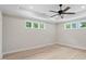 This bedroom features two windows, ceiling fan, and light wood flooring at 136 Digh Cir # 4, Mooresville, NC 28117