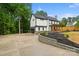 A two-story home boasts a black-trimmed exterior, front porch, large driveway and updated landscaping at 136 Digh Cir # 4, Mooresville, NC 28117