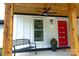 Welcoming front porch featuring a ceiling fan, seating, and a striking red front door at 136 Digh Cir # 4, Mooresville, NC 28117